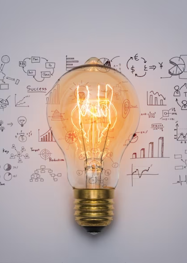 Light bulb glowing against a backdrop of business diagrams, graphs, and success strategies, symbolizing innovative financing solutions for real estate investments.