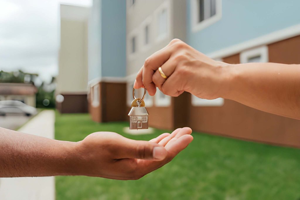 Key handoff representing commercial real estate loan closing in Florida with modern building in background
