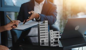 Construction loan consultation in Florida with professionals reviewing building plans and financial documents