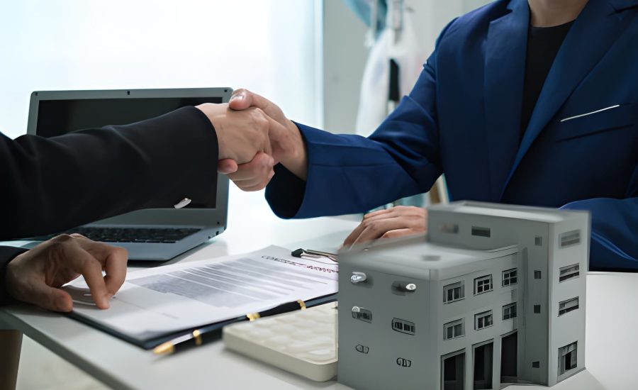 Business partners finalize commercial real estate loan deal in Florida with handshake and building model