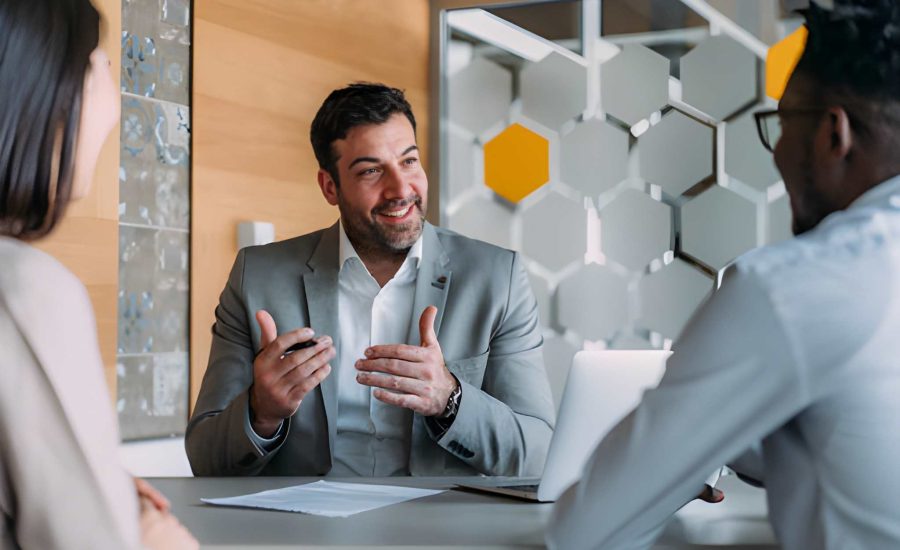 Loan companies in Jacksonville Florida financial advisor consulting clients in modern office setting