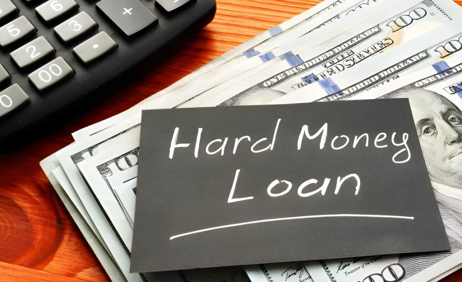 Hard money mortgage lenders—stack of $100 bills, calculator, and handwritten loan note on wooden surface
