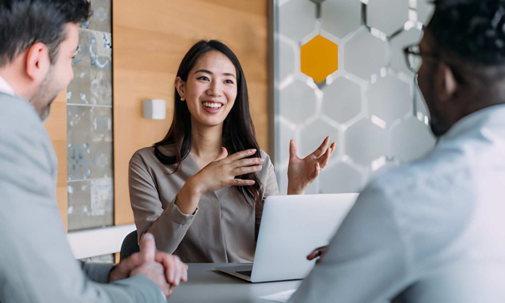 Loan companies in Jacksonville Florida advisor leading strategic financial discussion with clients in modern office