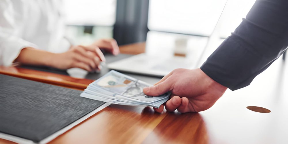 Private money lenders Florida facilitating direct cash exchange in office setting with professional oversight.